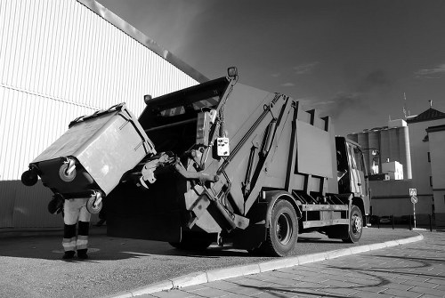 Construction site with builders clearing waste in Uxbridge